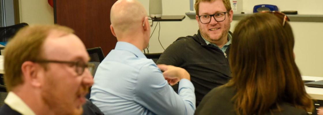 A DRCGO employee talking to a group of people at a Way to Go event.