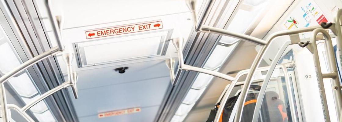 An emergency exit sign on a RTD train. 
