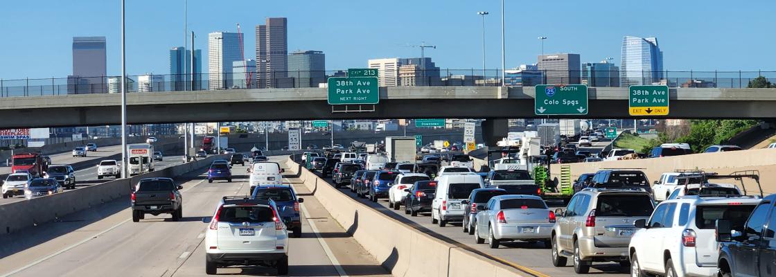 Heavy traffic on Interstate 25 with the downtown Denver skyline in the background